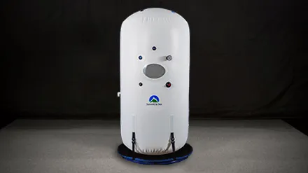 The Dive Vertical, a tall white Summit to Sea chamber standing upright on a round base.