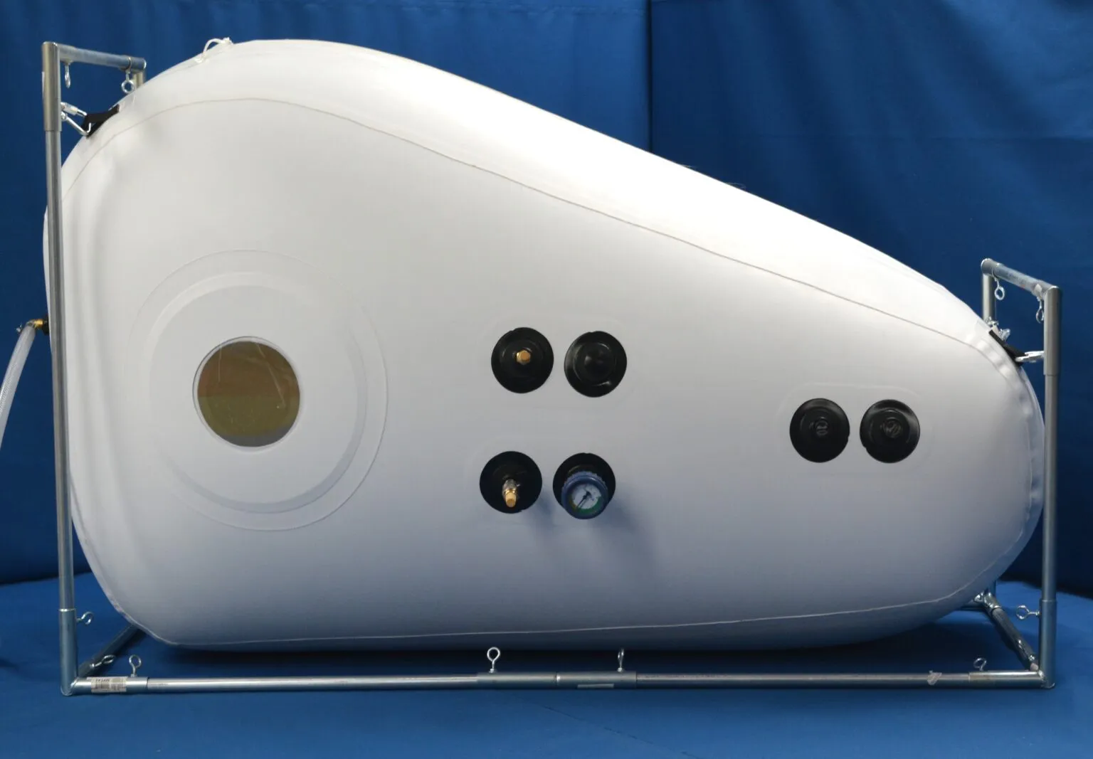 The Newtowne Standard Shoe, a white chamber that rises at one end for sitting up, in a steel frame.