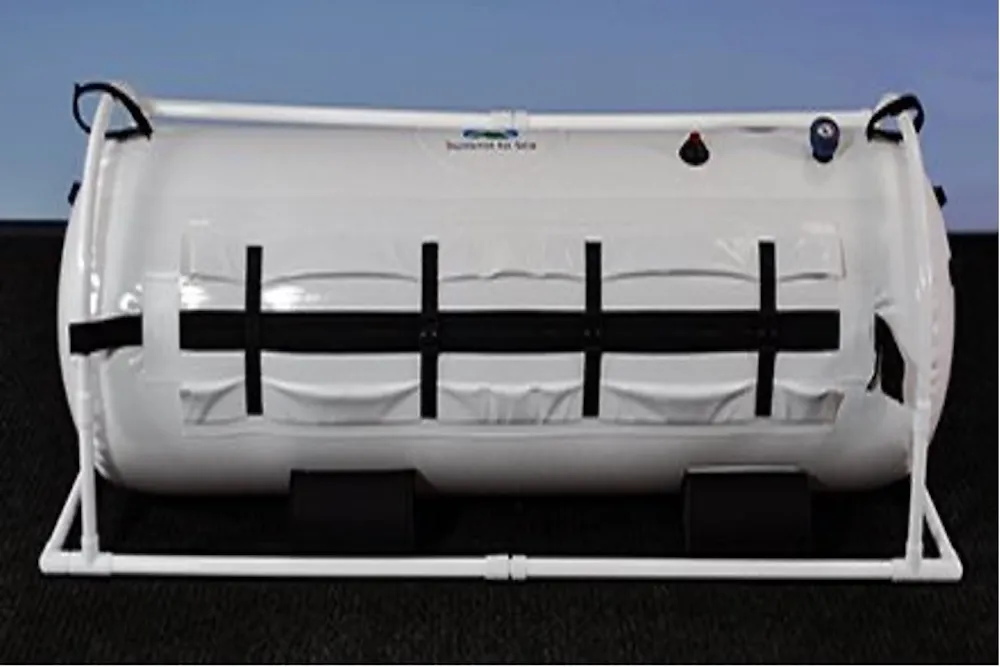 The Shallow Dive, a white Summit to Sea chamber lying on its side in a white frame.